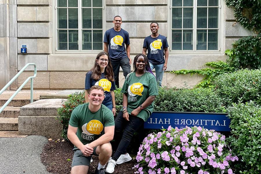 Peer advisors pose for the camera in front of Lattimore Hall.