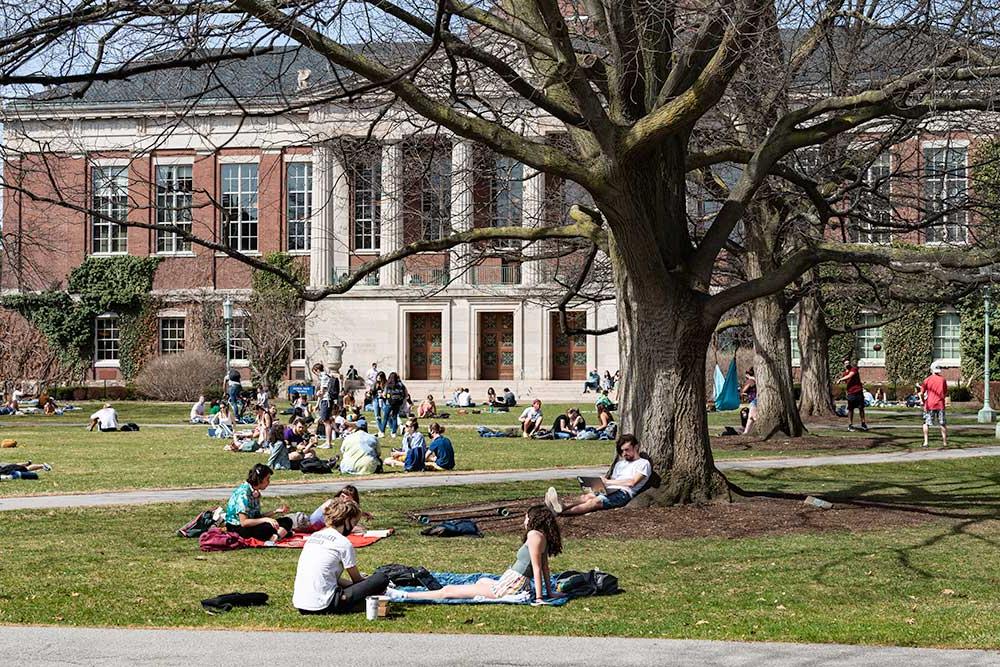 Students sitting in groups on the Eastman Quad.